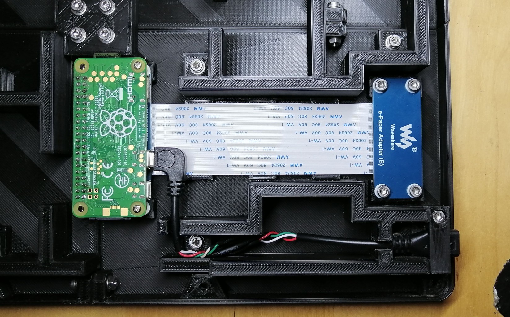a detail of the Raspberry Pi zero, the adapter card and the USB connector inside the case